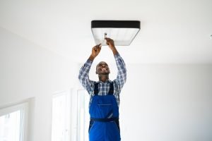 Electrician Near Me In Spring Hill TN Electrician Installing Lighting Fixture - Electrician Near Me inKansas City TN